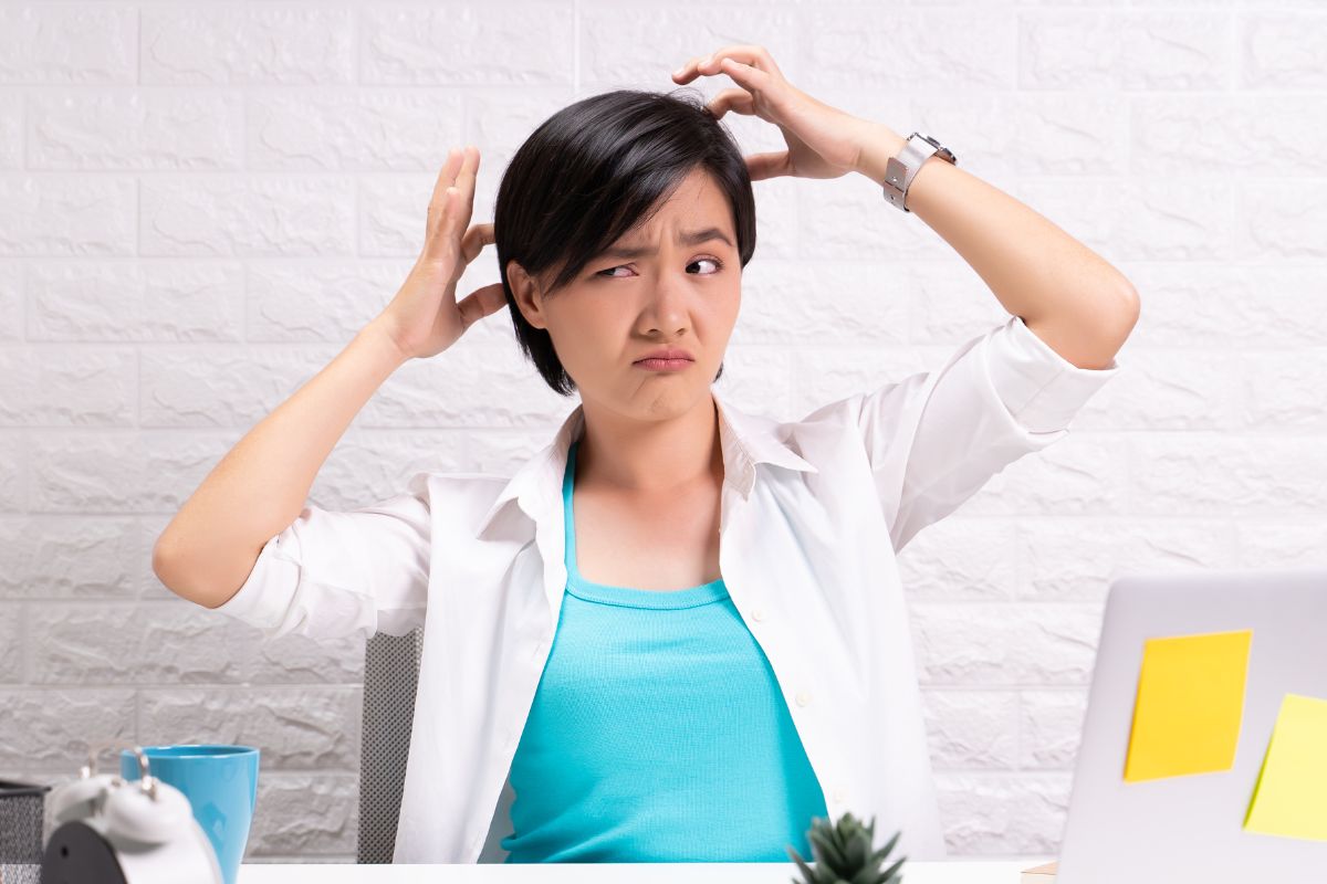 A picture of someone scratching their head.