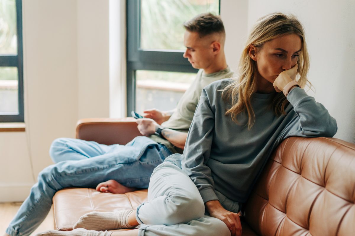 A picture of a couple ignoring each other.