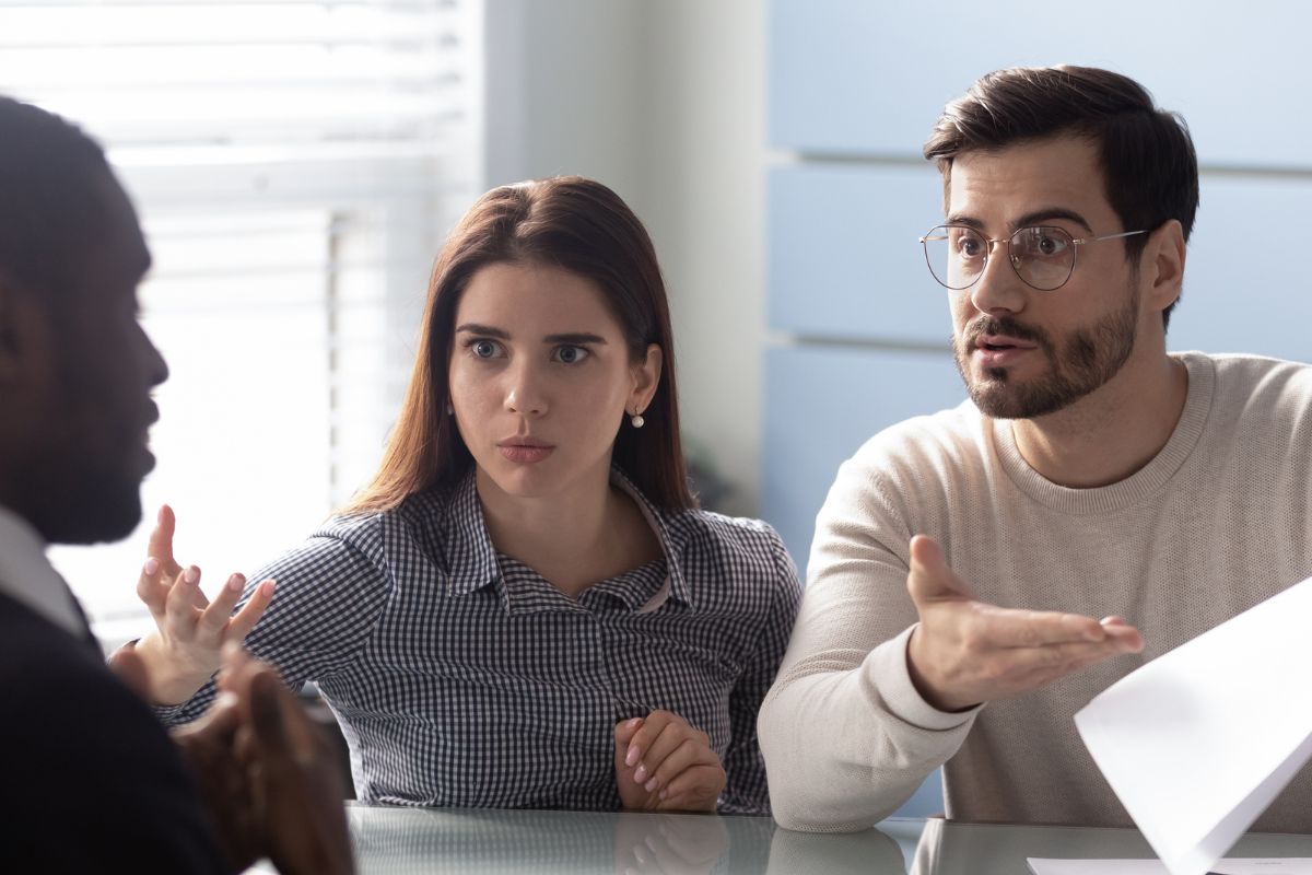 A picture of a couple talking to someone.