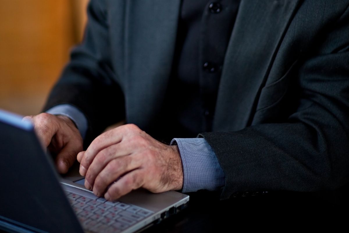 A picture of an elderly person researching.