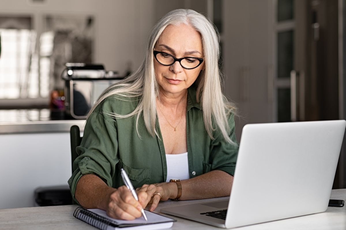 A picture of an elderly person researching.