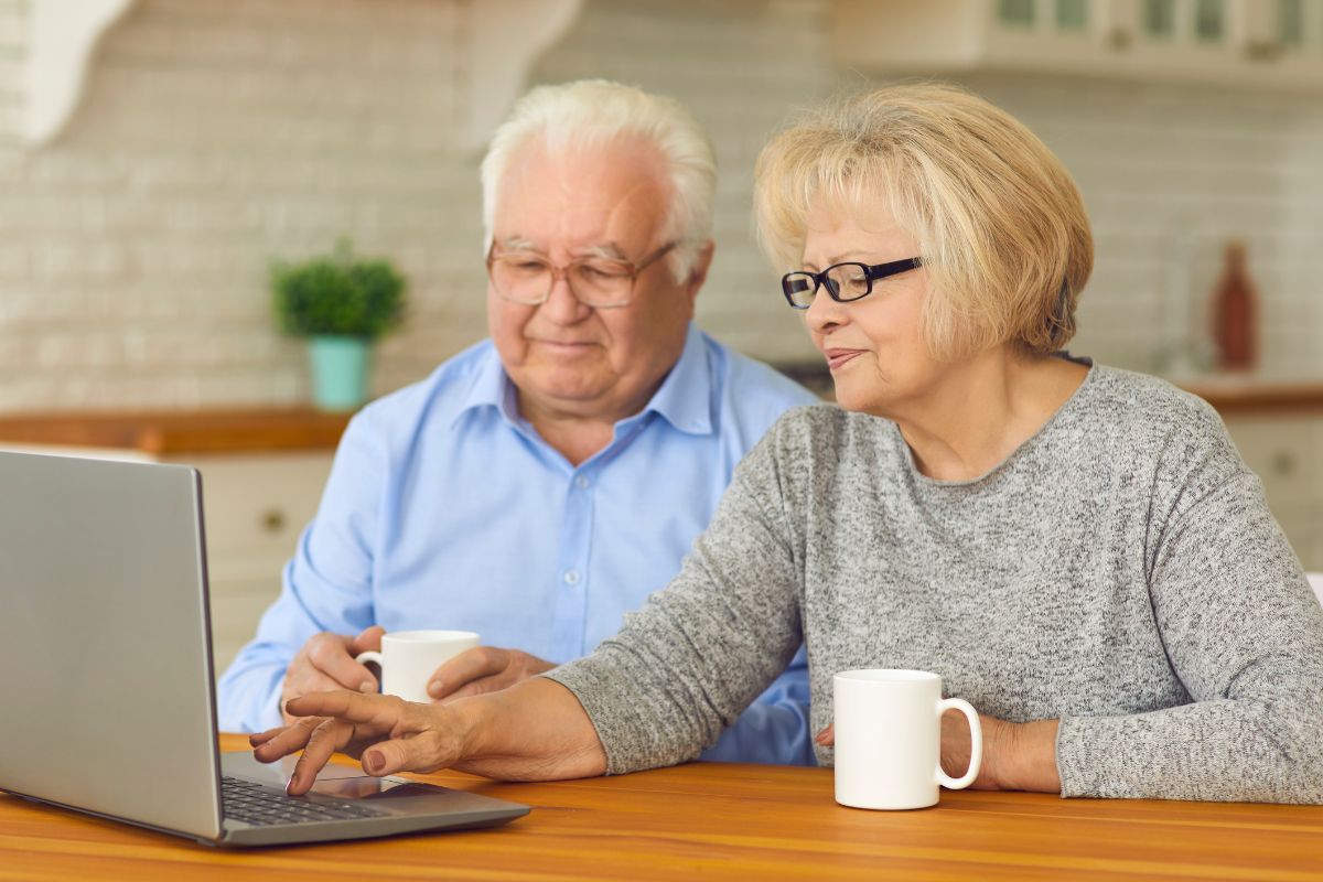 A picture of an elderly couple researching.
