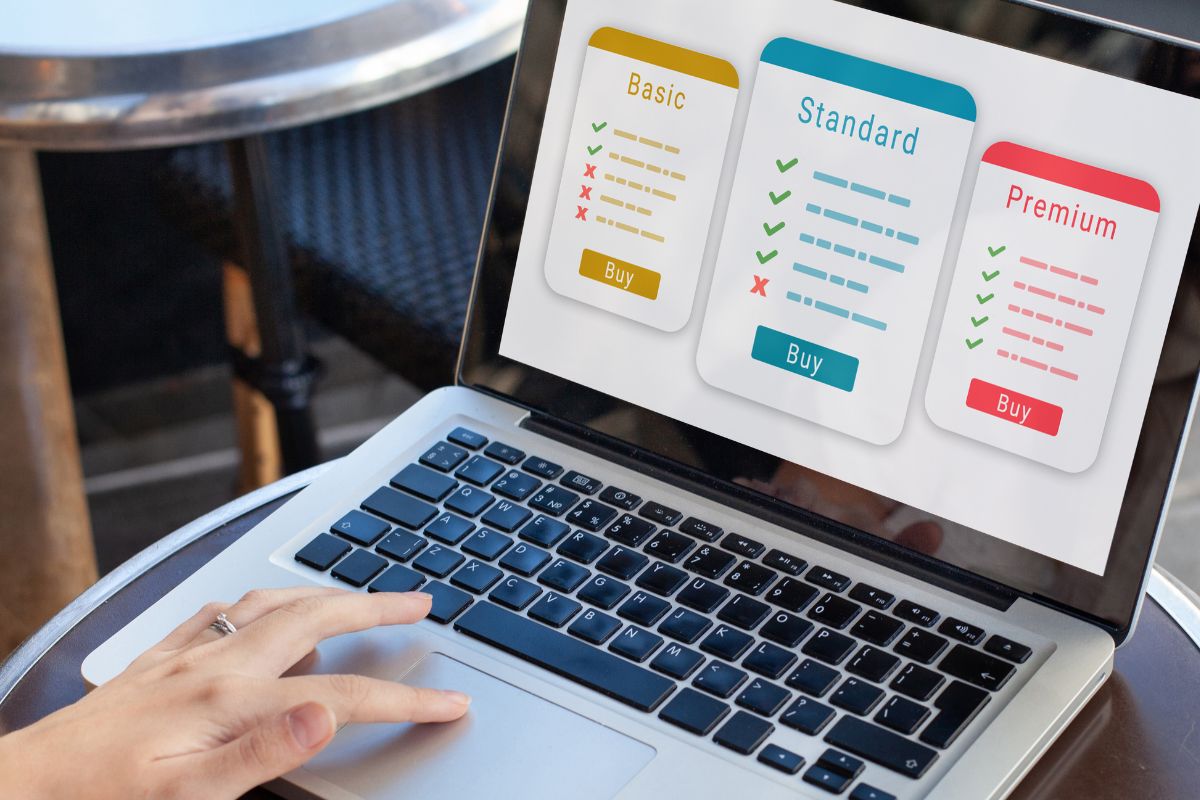 An image of a woman's hand using a laptop.