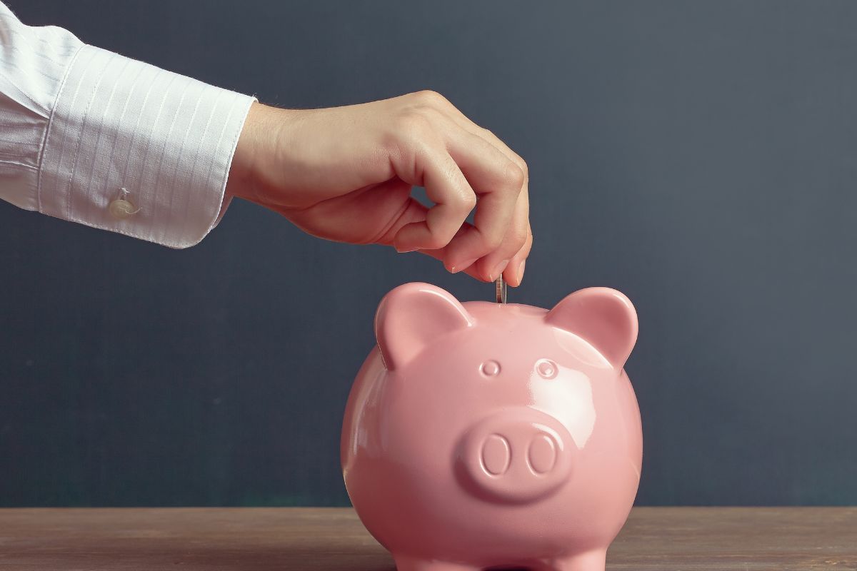 A picture of a woman's hand saving money.