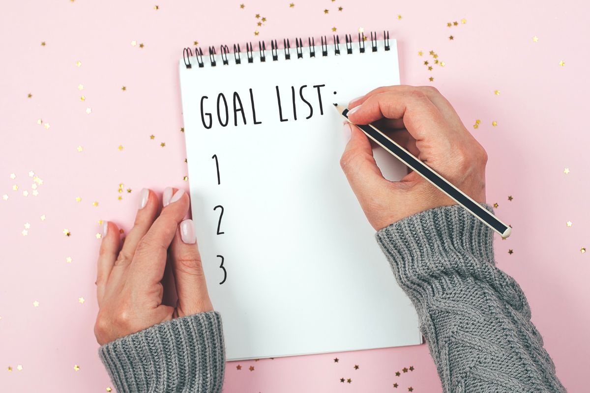 A picture shows a woman's hand setting goals.