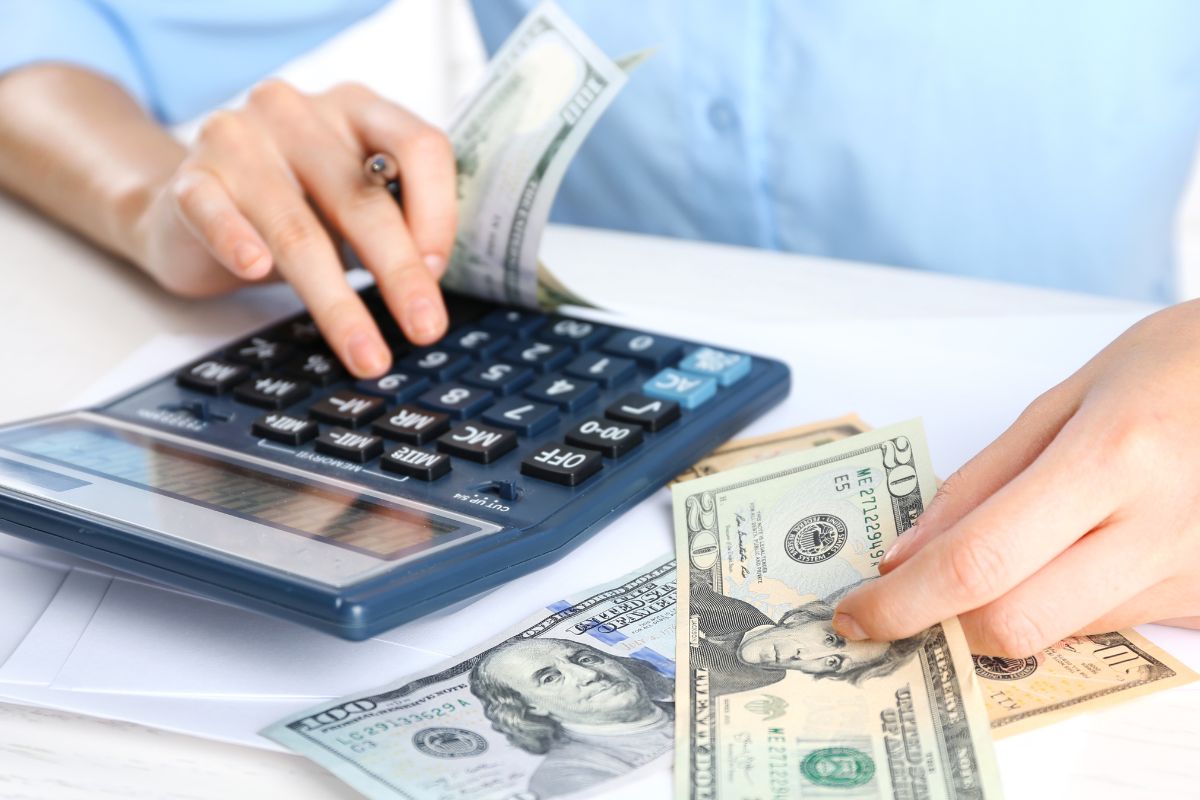 An image shows a woman calculating her money.