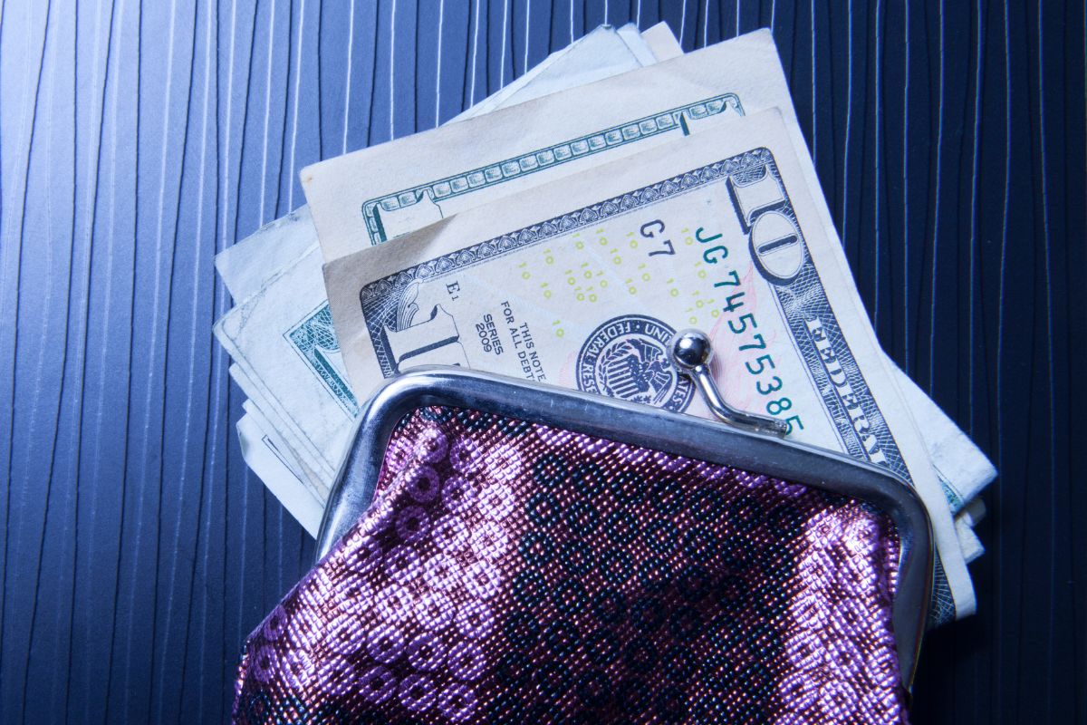 A picture of a wallet and dollar bills.