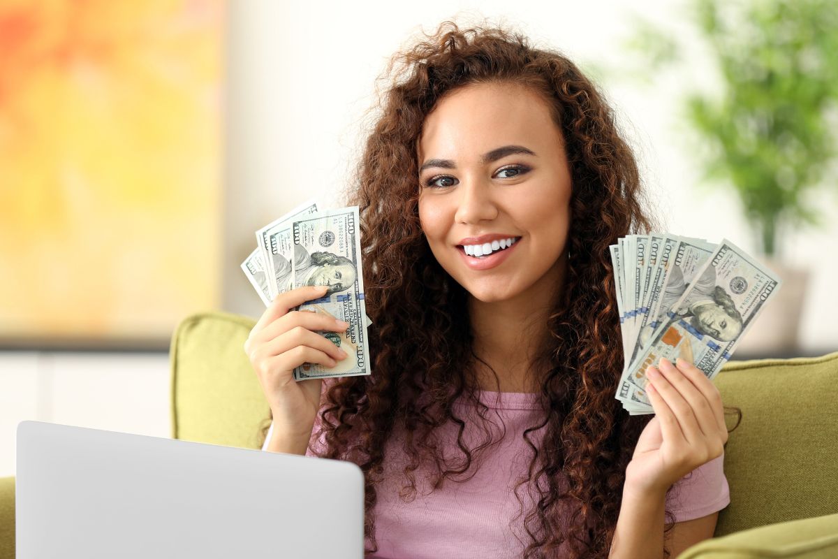 An image of a woman holding money.