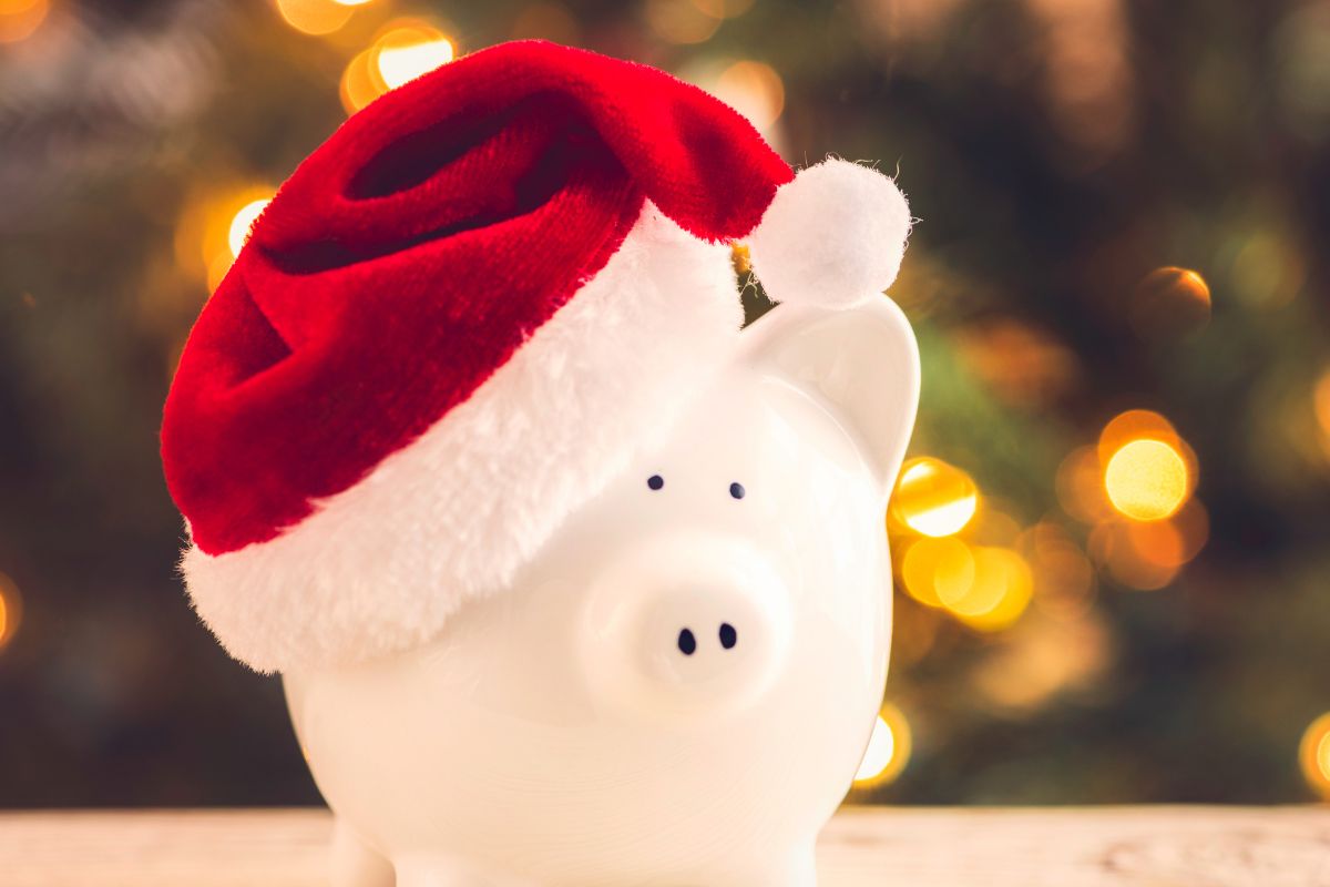 A picture shows a Christmas hat and a piggy bank.