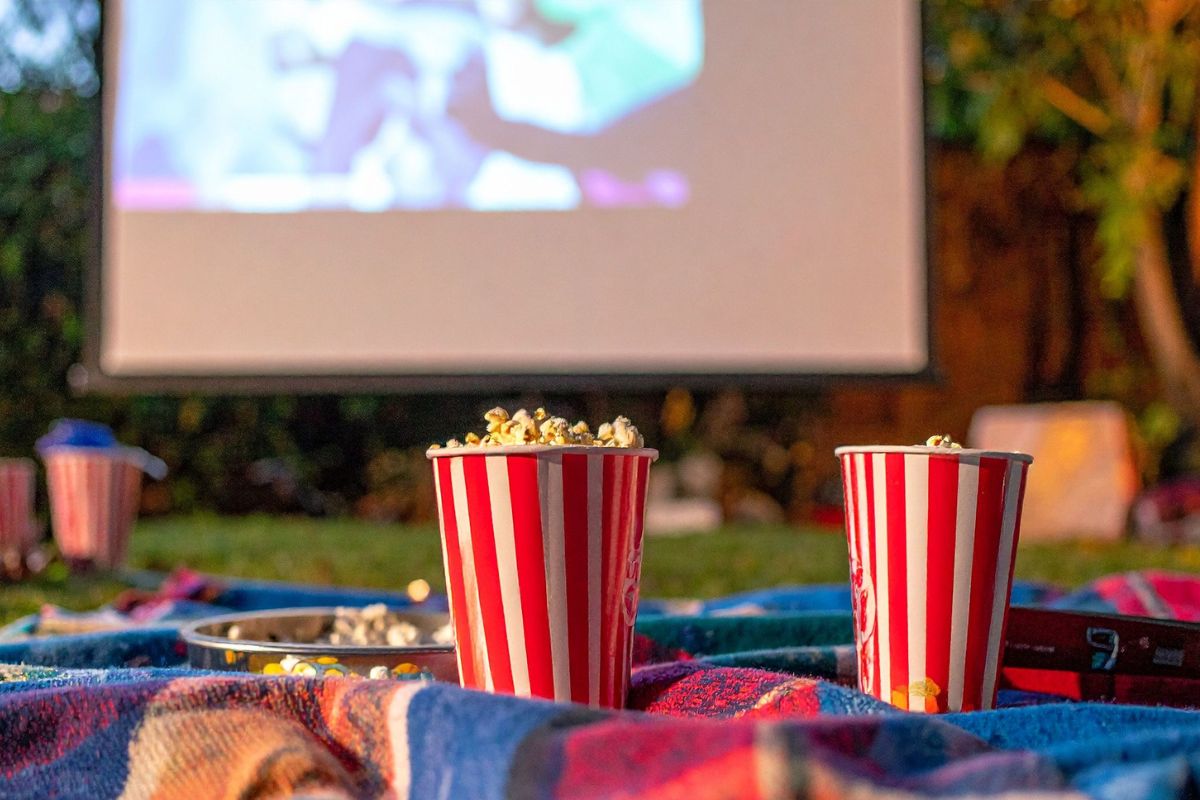 A picture of popcorn and a movie screen.