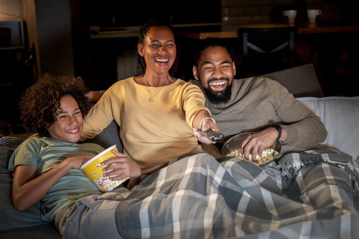 An image shows a happy family watching a movie.