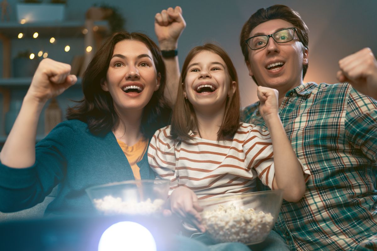 An image of a family watching a movie with fun.