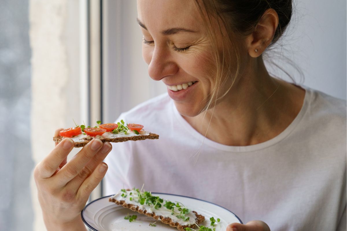 A picture of a woman eating a snack.
