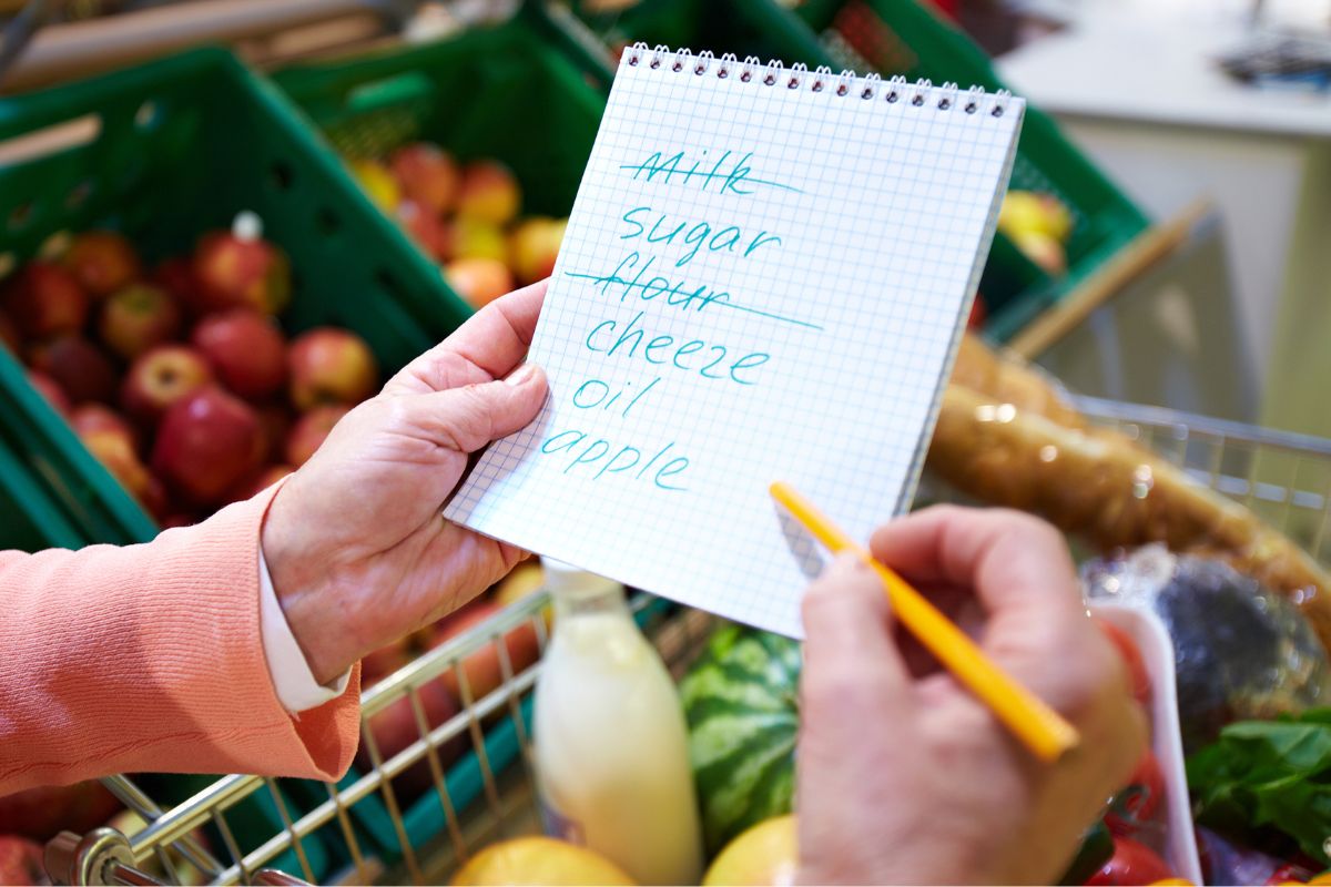 A picture shows a woman checking her grocery list.