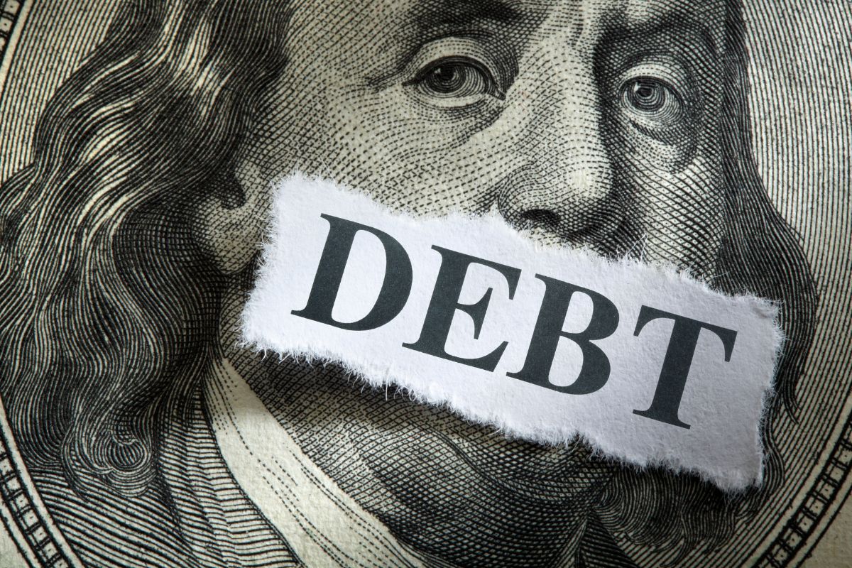 A picture of a paper with debt wording.