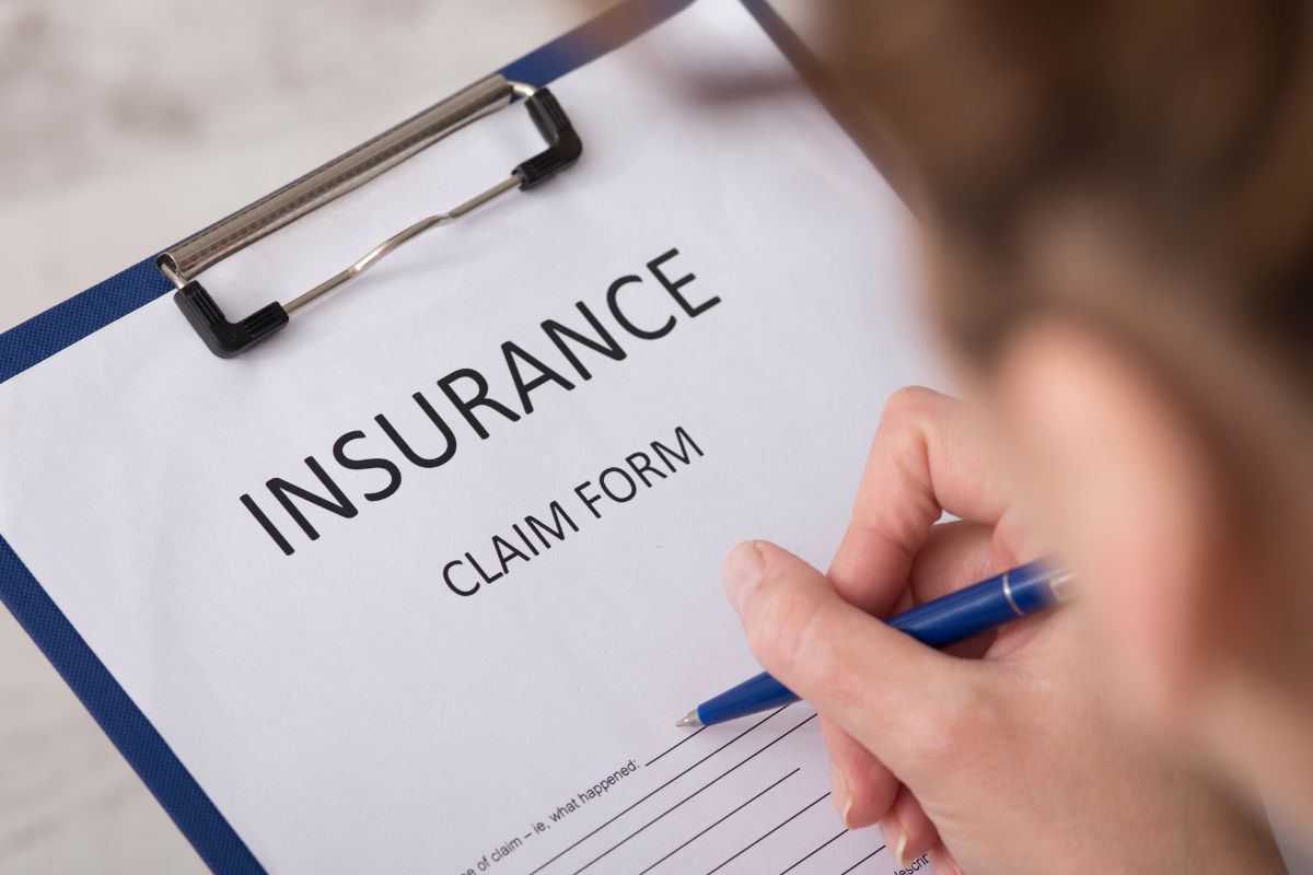 An image of a woman filing out an insurance form.