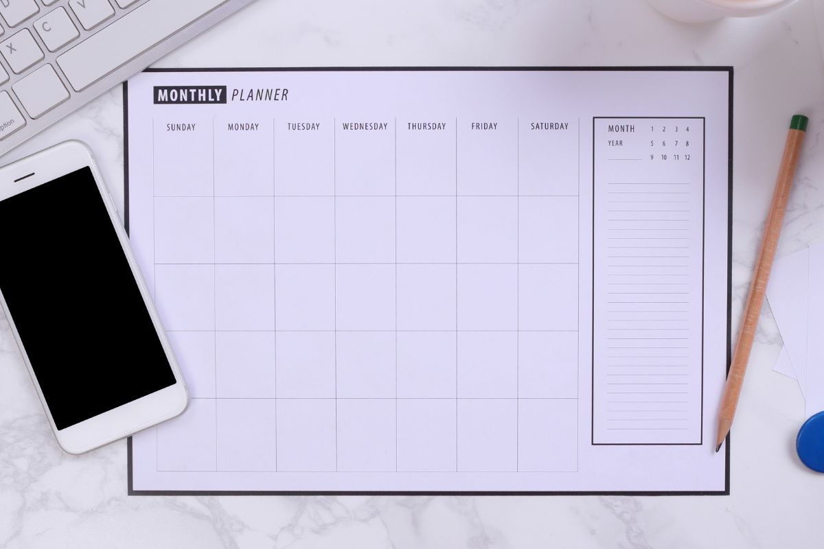 An image shows a monthly planner and a phone.