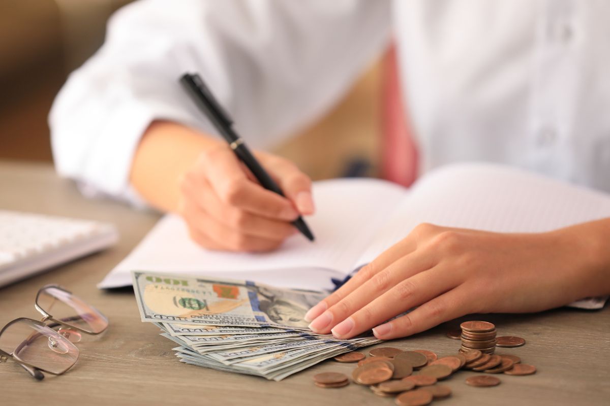 An image shows a woman setting a spending budget.