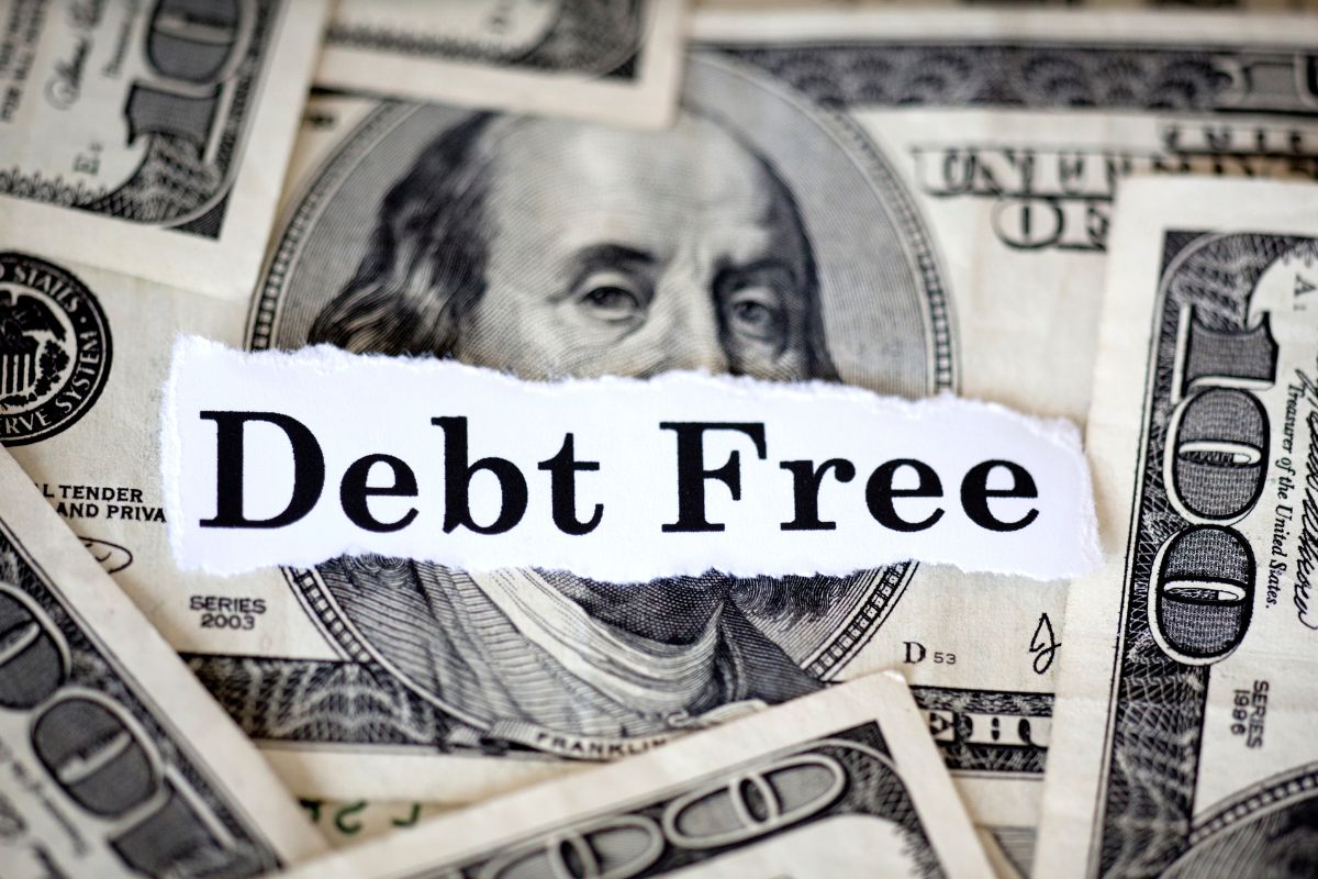 A picture of money and debt-free wording.