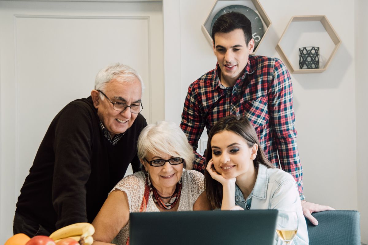 A picture shows a family using a laptop.