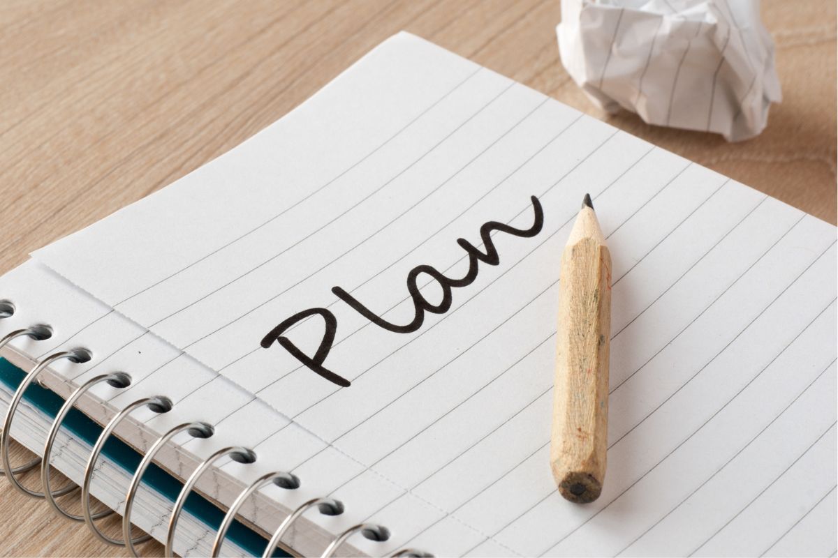 A picture of a notebook with a plan word.
