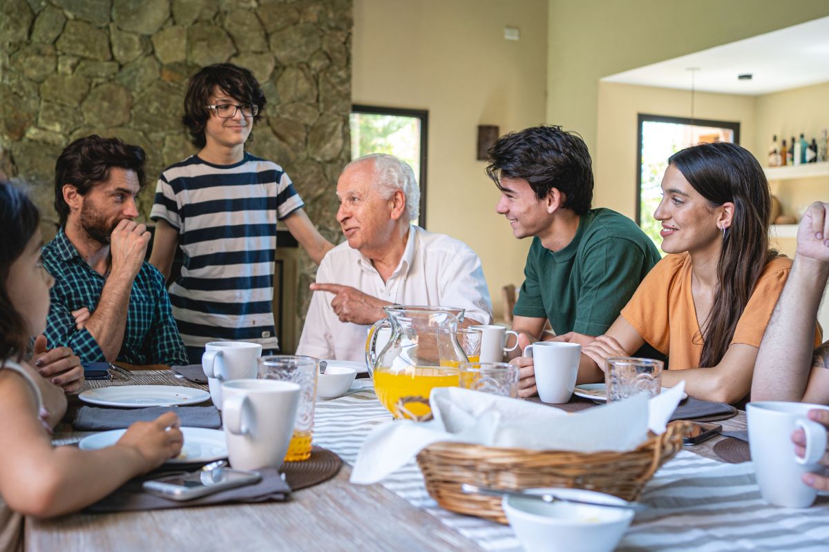 An image shows a family talking over the meal.