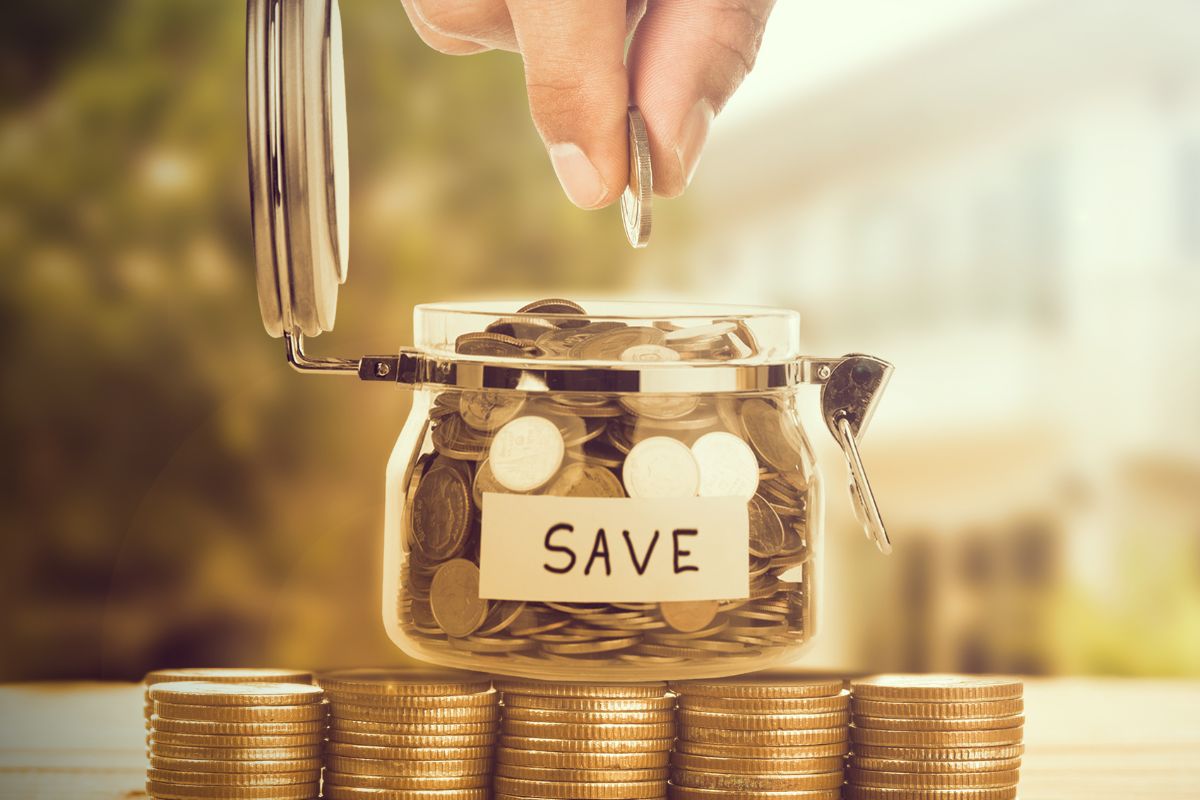 A picture tells about a man's hand saving money.