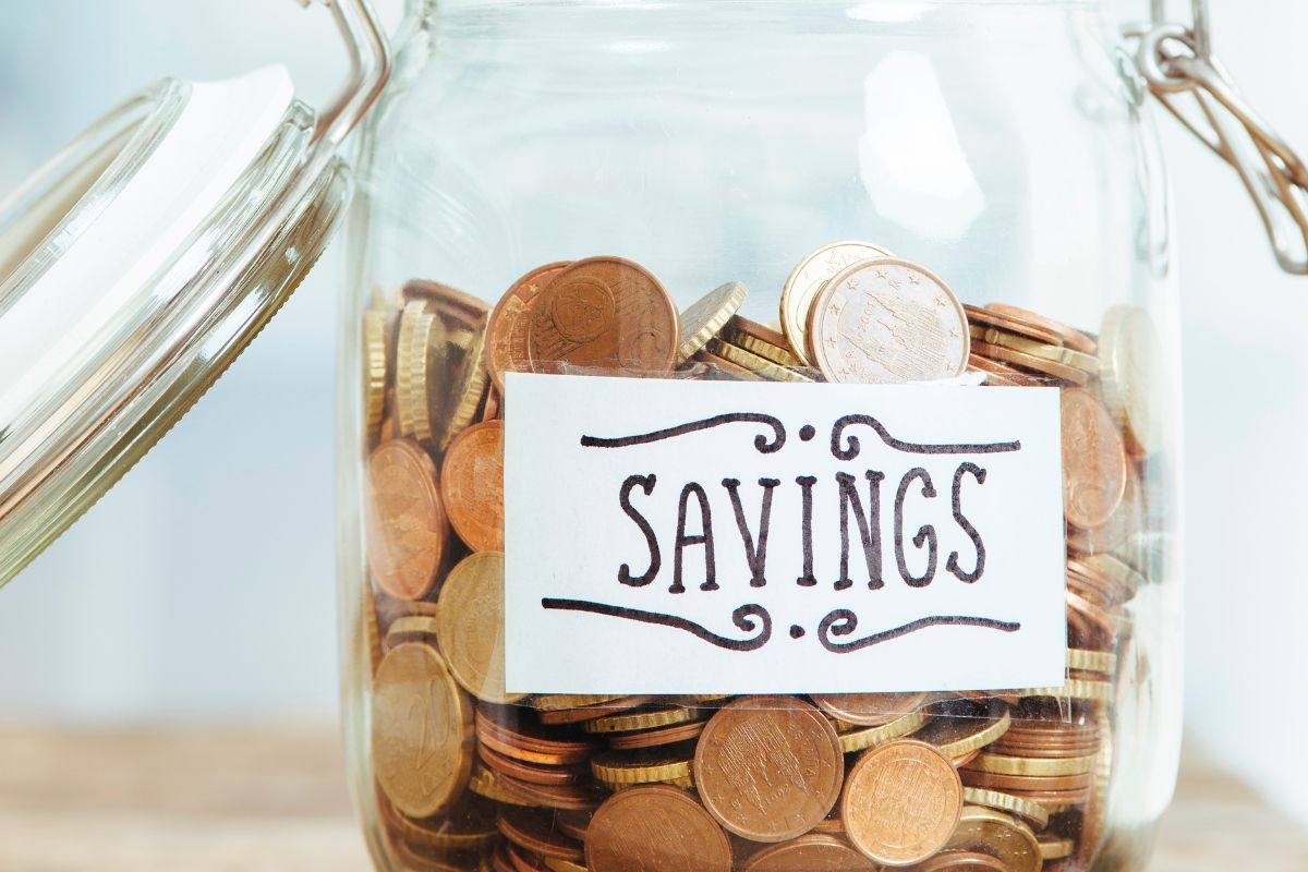 An image shows a jar of savings.