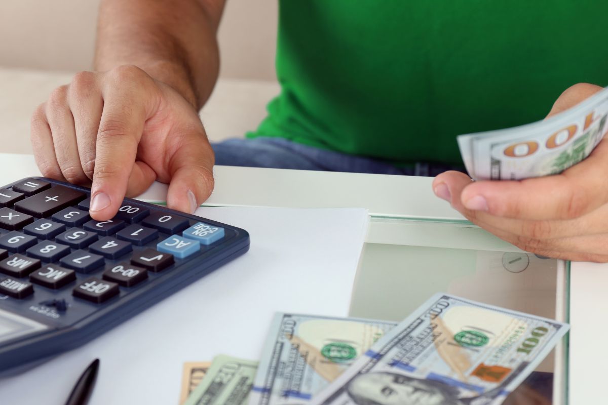 A picture shows a man calculating his money.