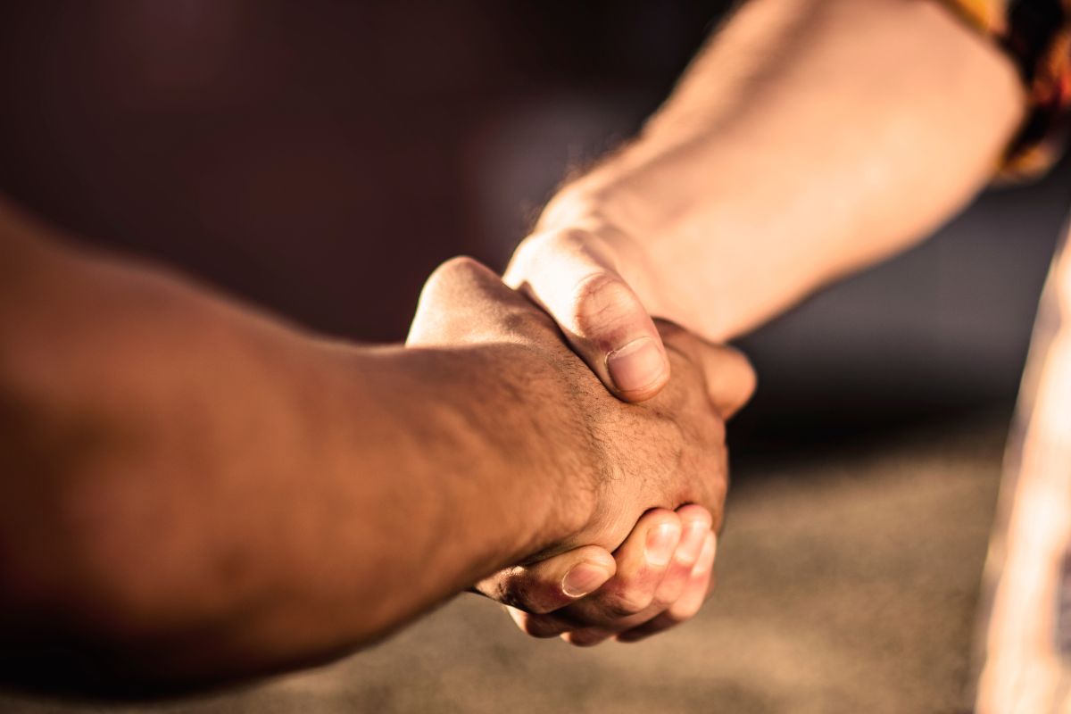 A picture shows two hands shaking.