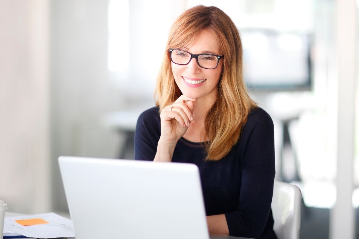 A picture of a woman using a laptop.
