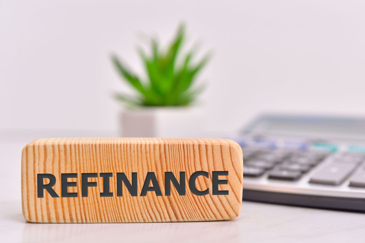 An image of a refinance wording on a wooden object.