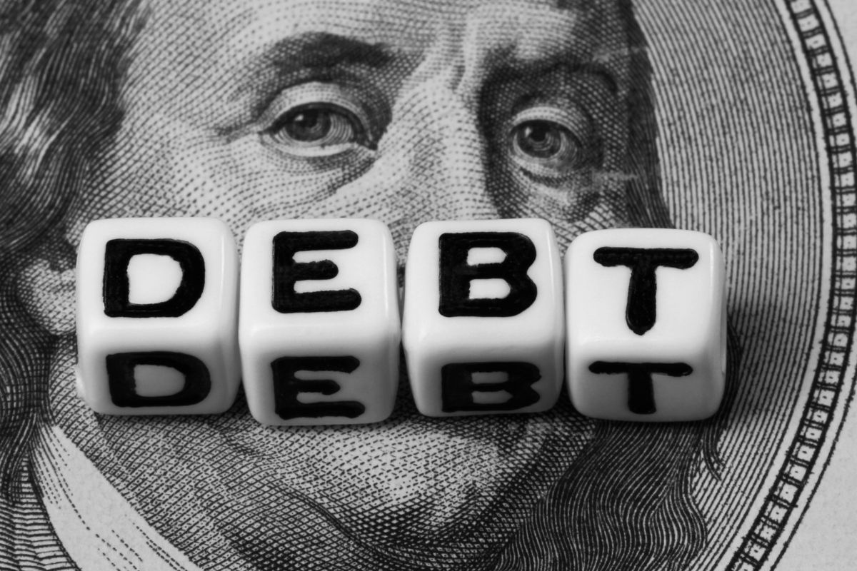 A picture of the word debt on cubes.