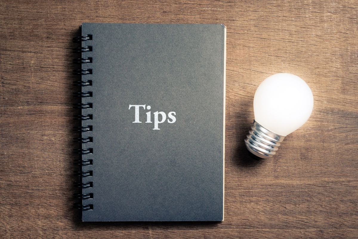 An image of a bulb and a notebook with tips wording.