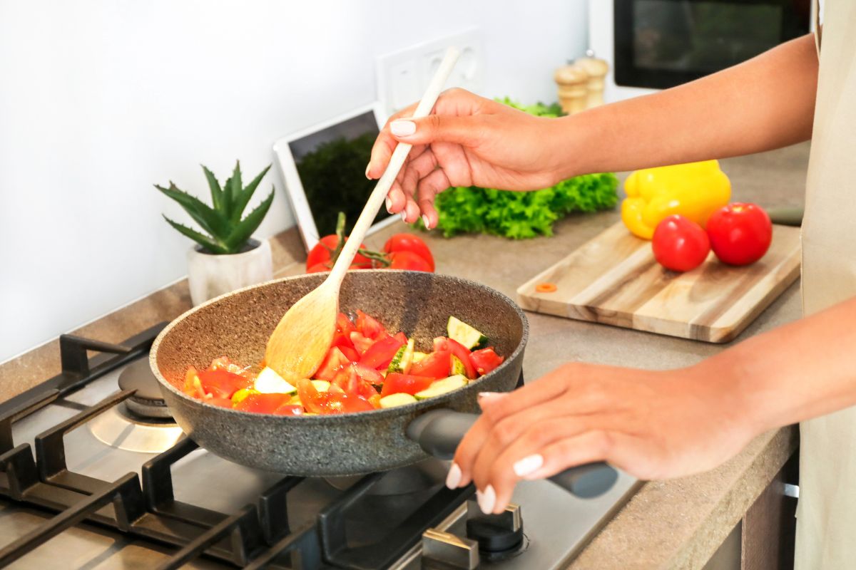 A picture shows a woman cooking a meal.