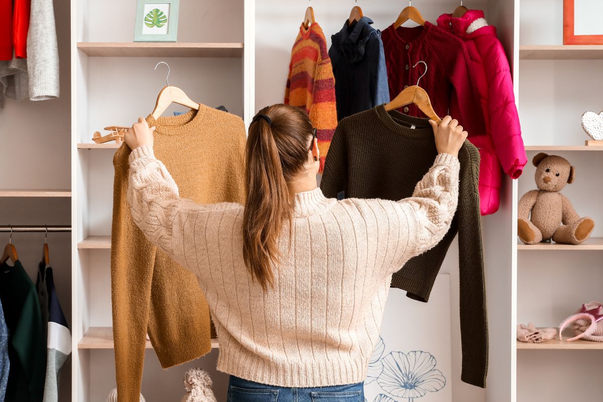 An image of a woman choosing a cloth to wear.
