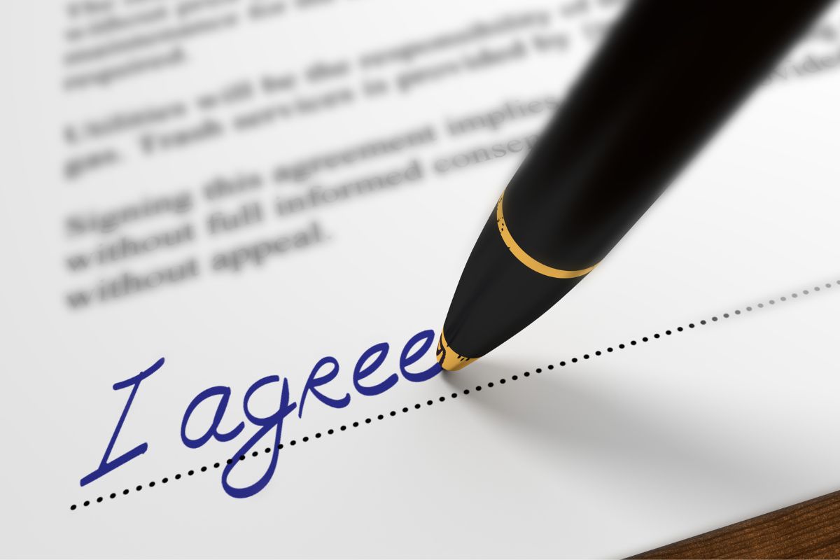 An image shows an agreement paper.