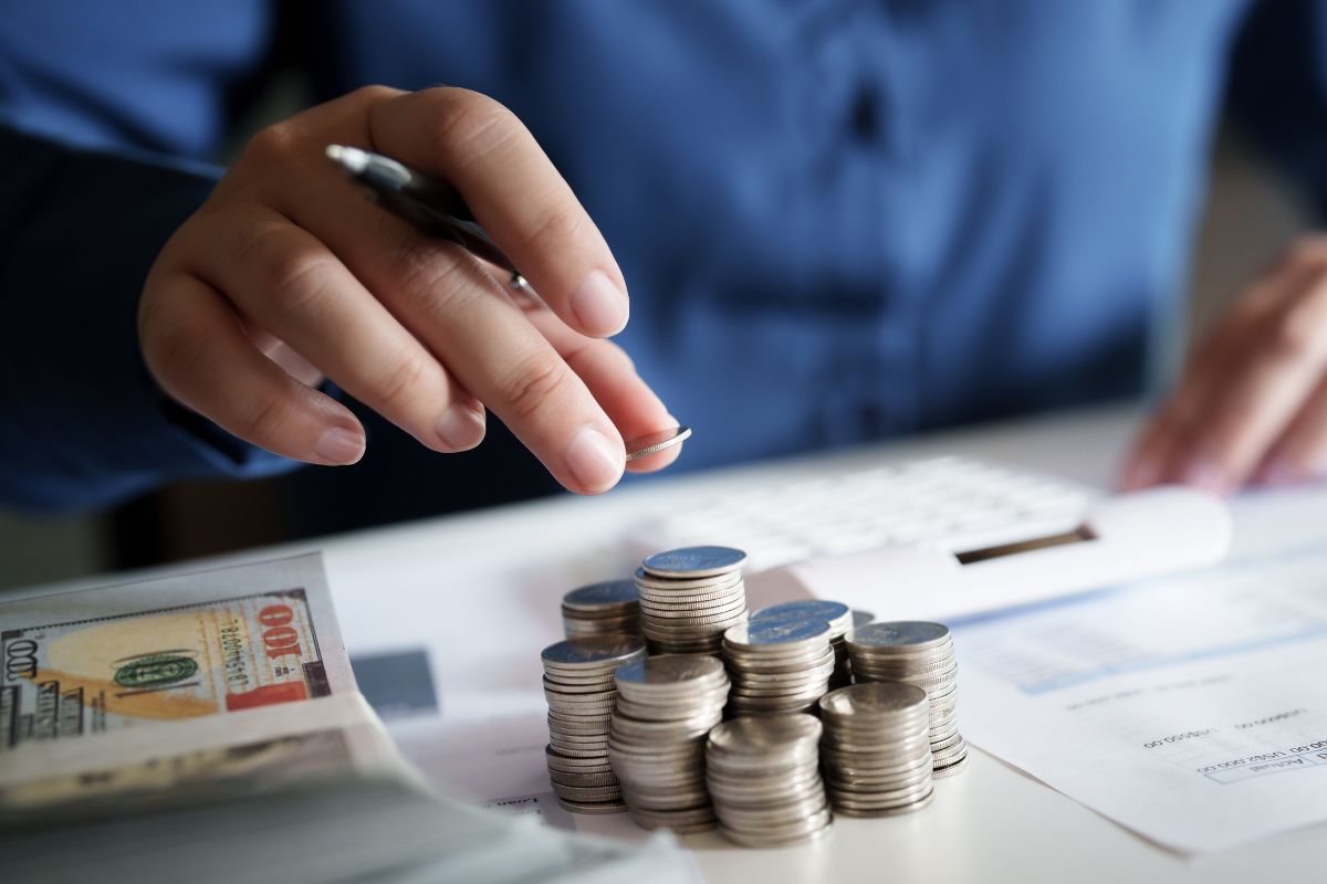 An image shows a man budgeting his money.
