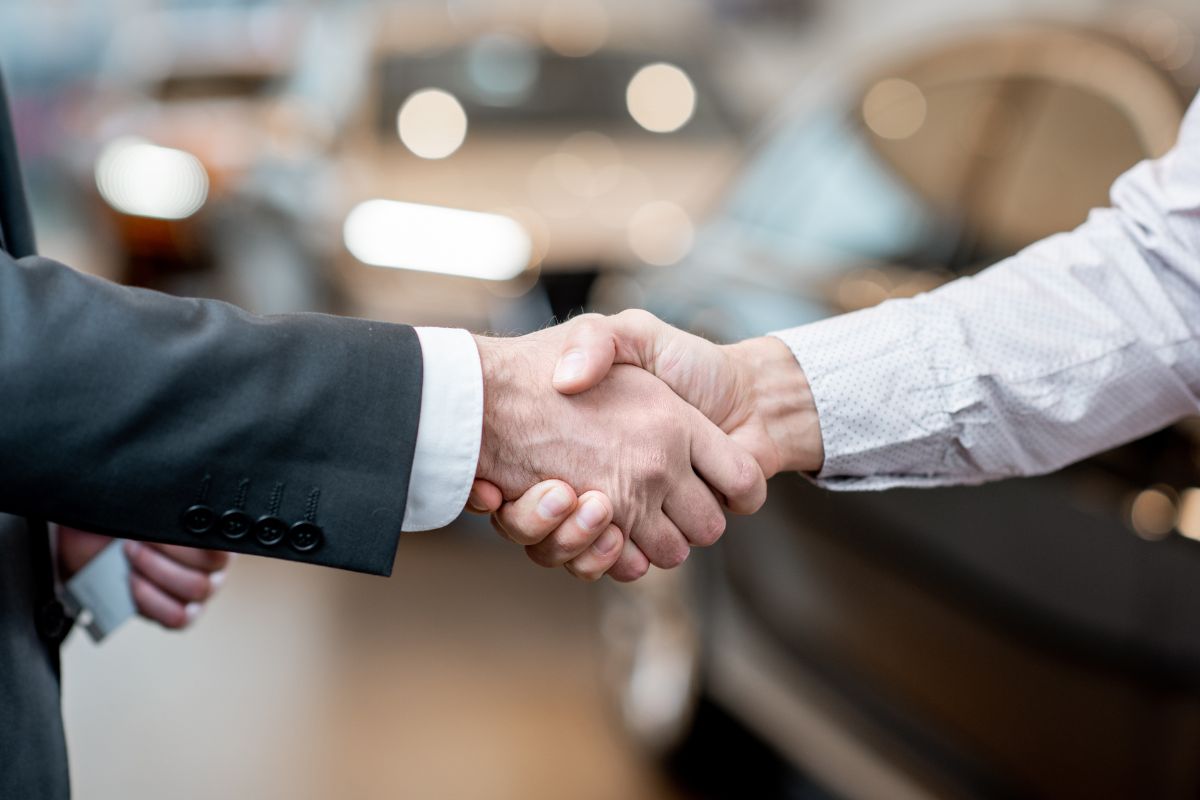 A picture shows two people handshaking.