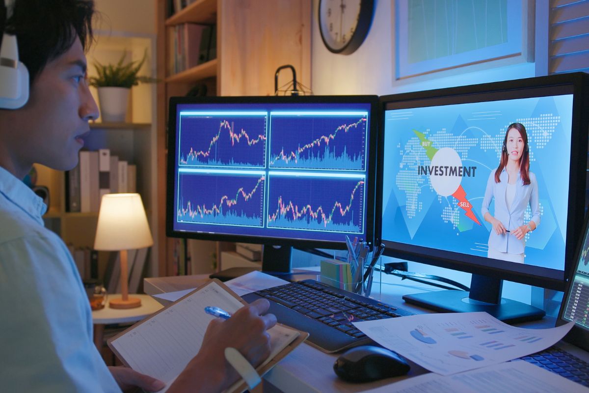 An image of a man learning about investment online.