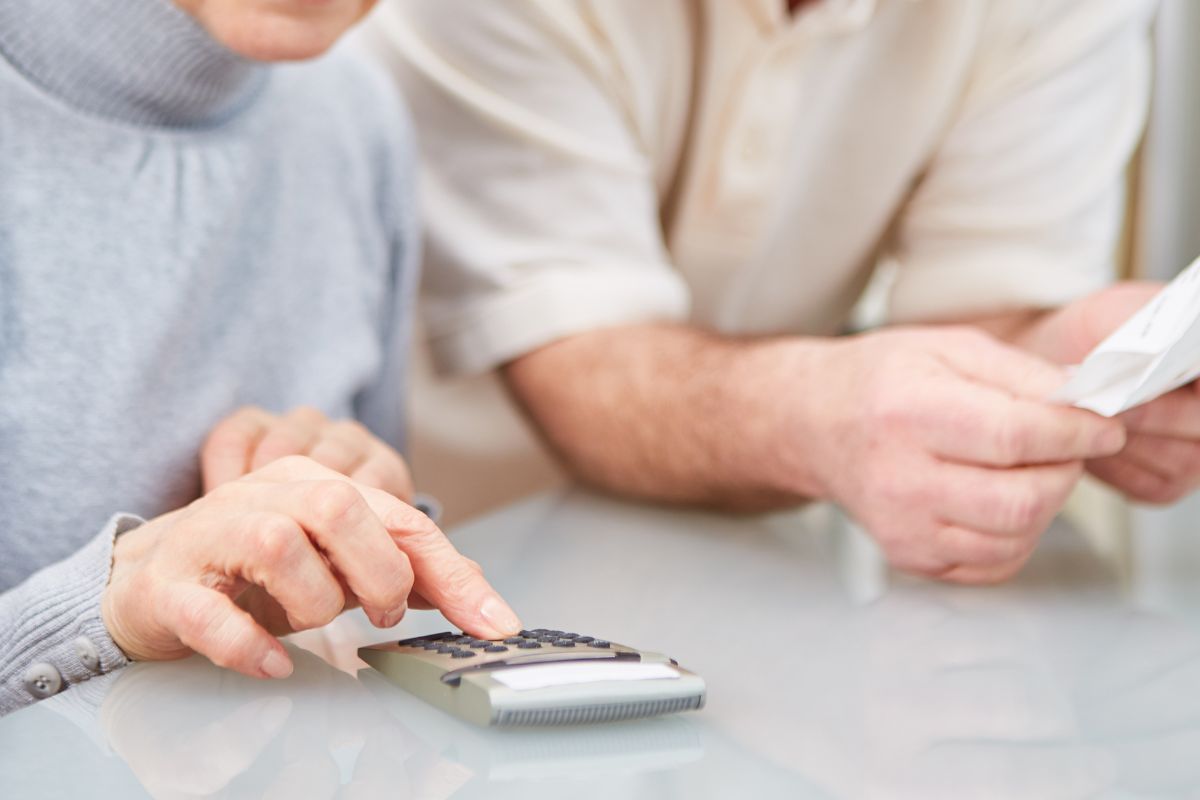 A picture of an elderly lady calculating something.