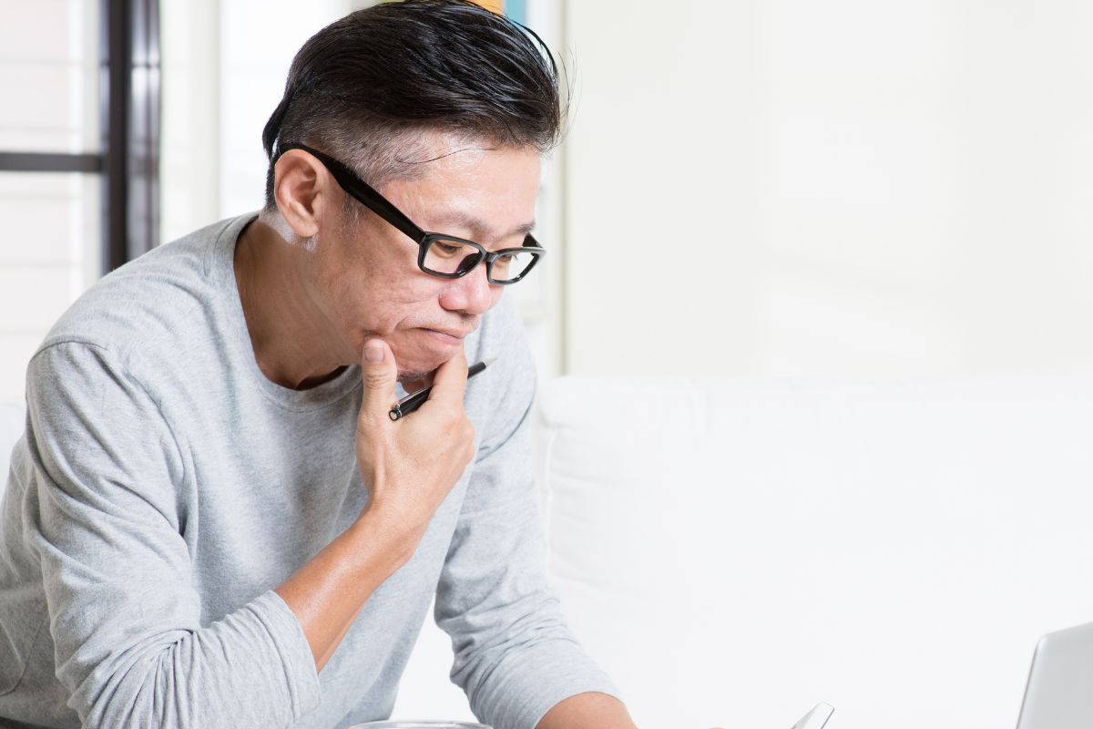 A picture of an elderly man thinking.