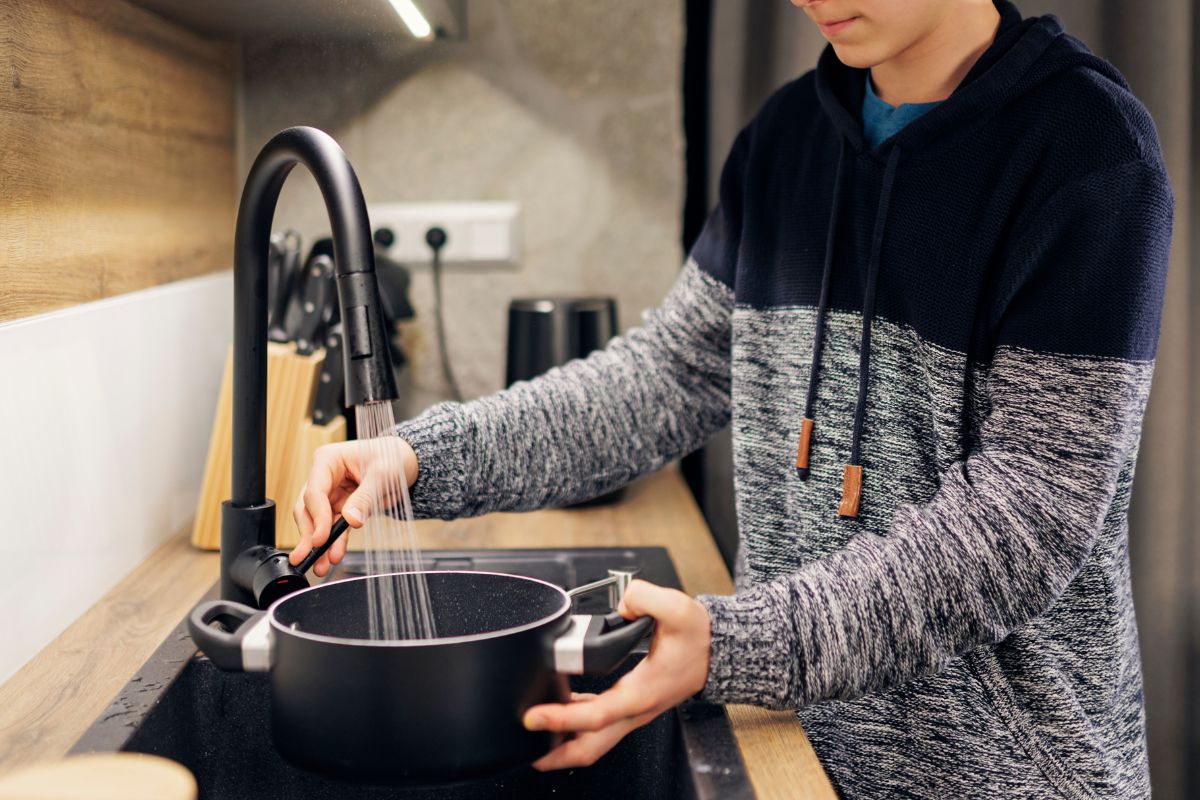 A picture of a teen cooking.