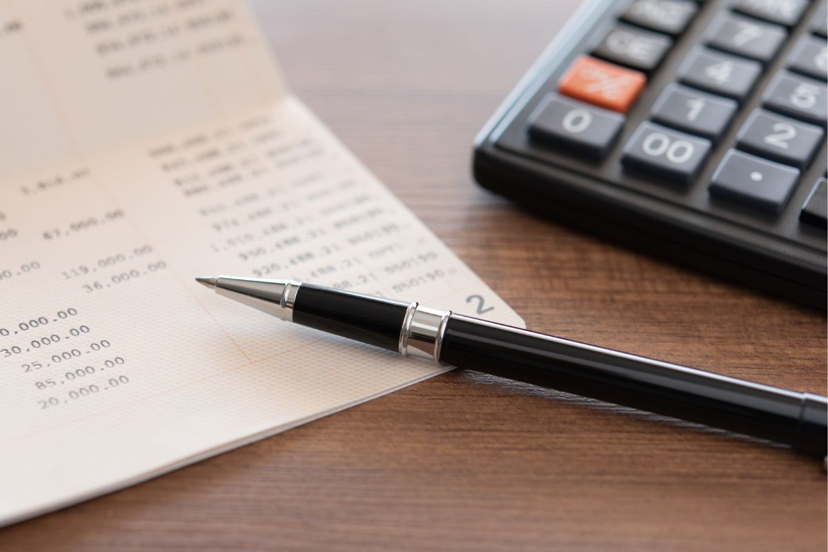 A picture of someone recording their bank account.