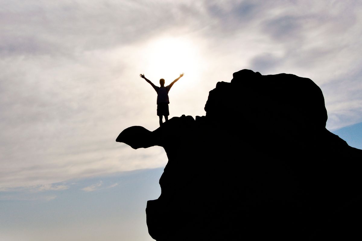 A picture of someone at the top of a mountain.