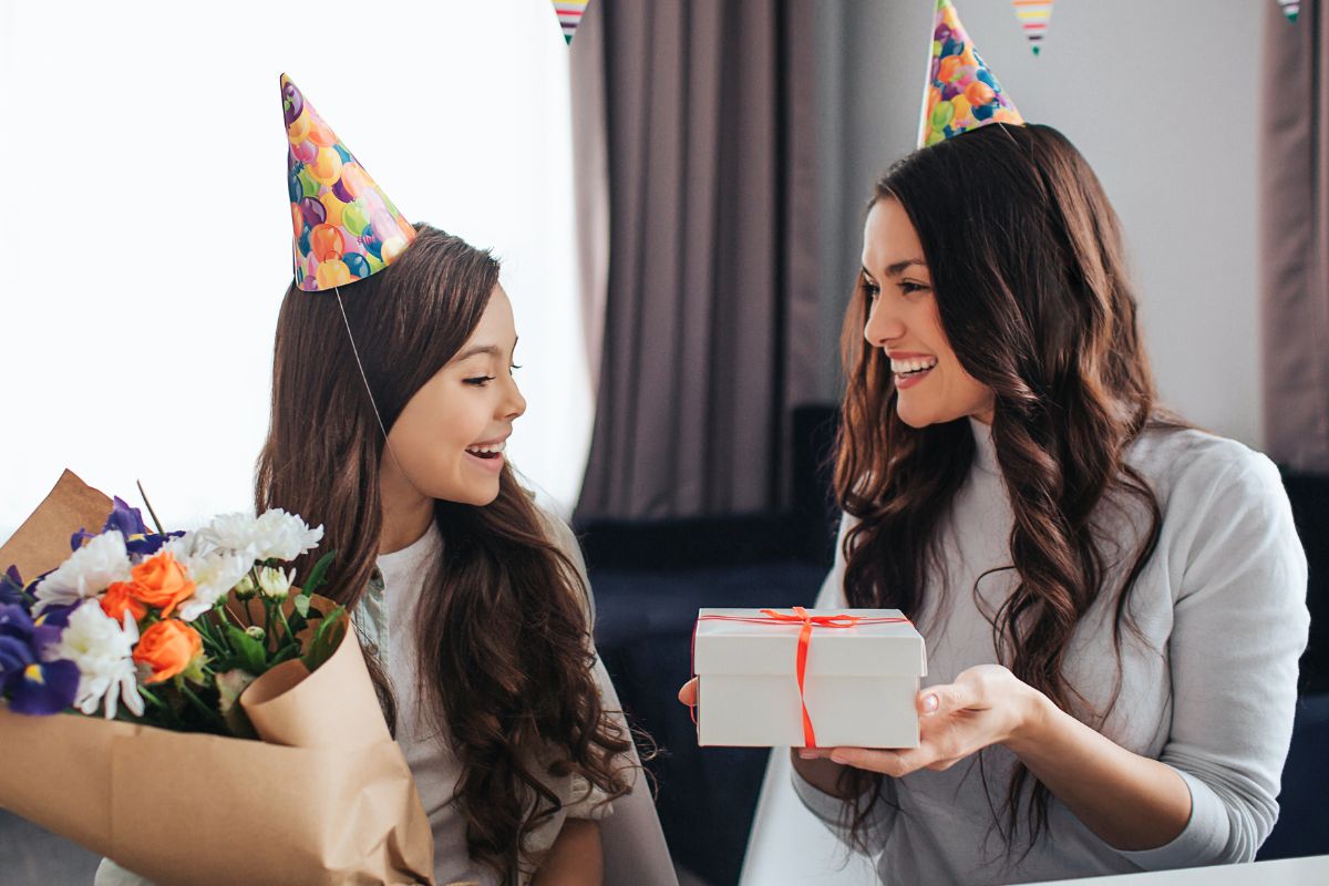 A picture of a mom giving a gift to her daughter.