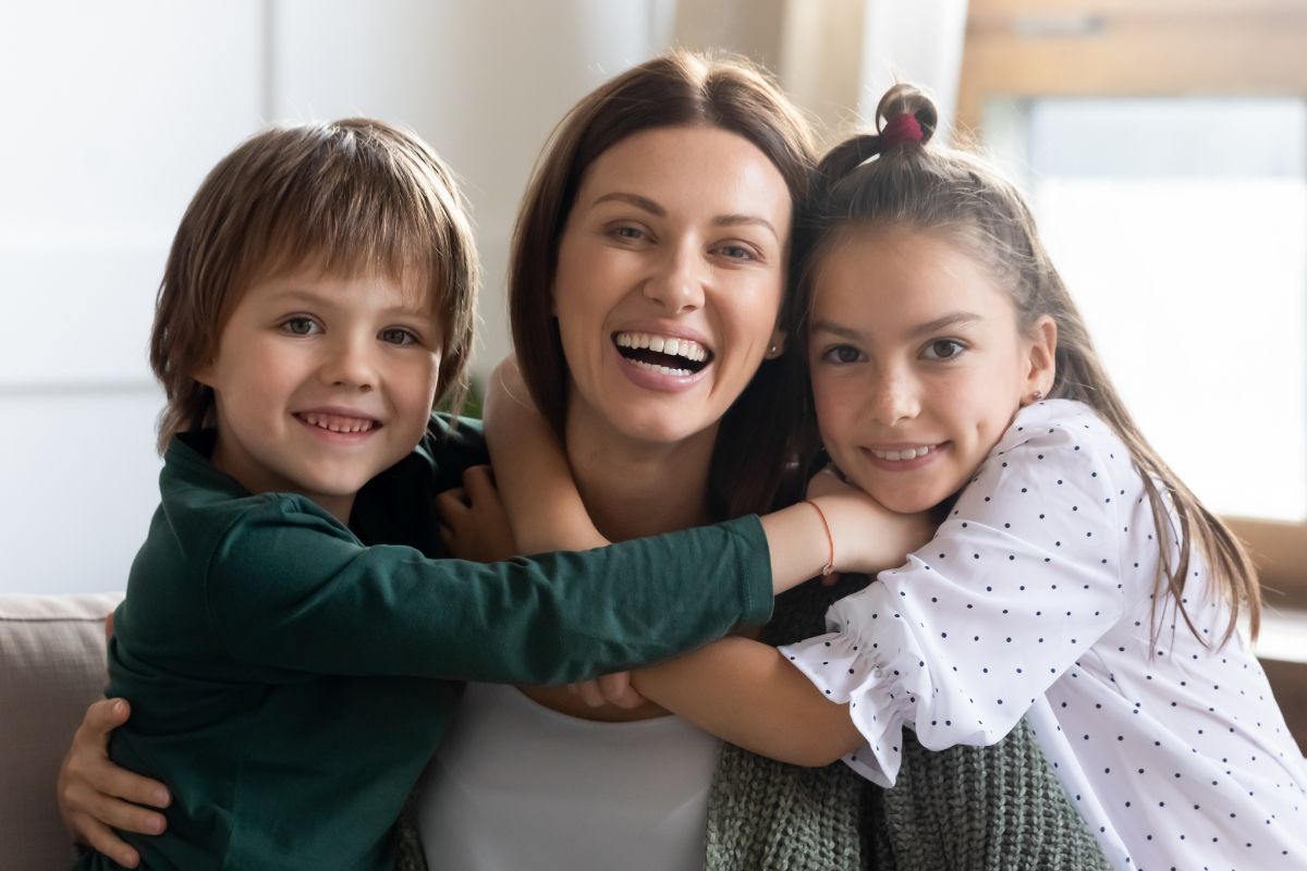 A picture of a happy mom and kids.