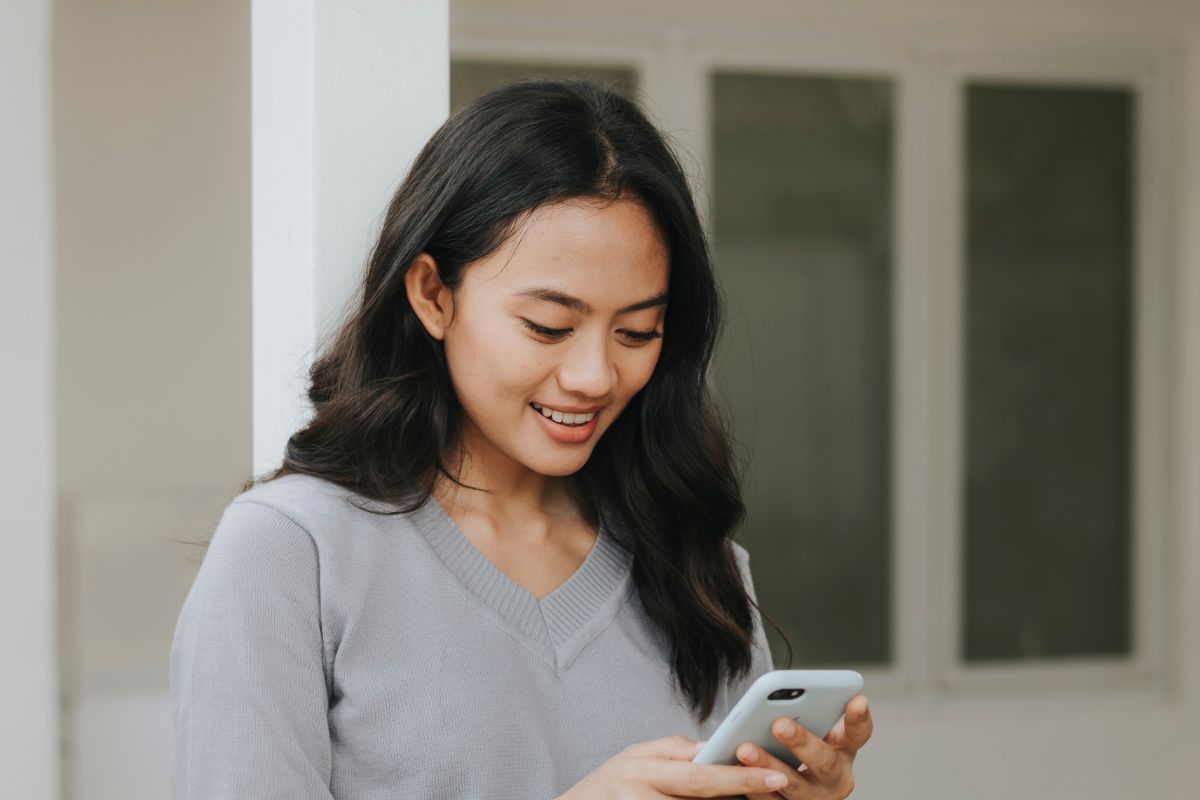 A picture of a lady looking at her phone.