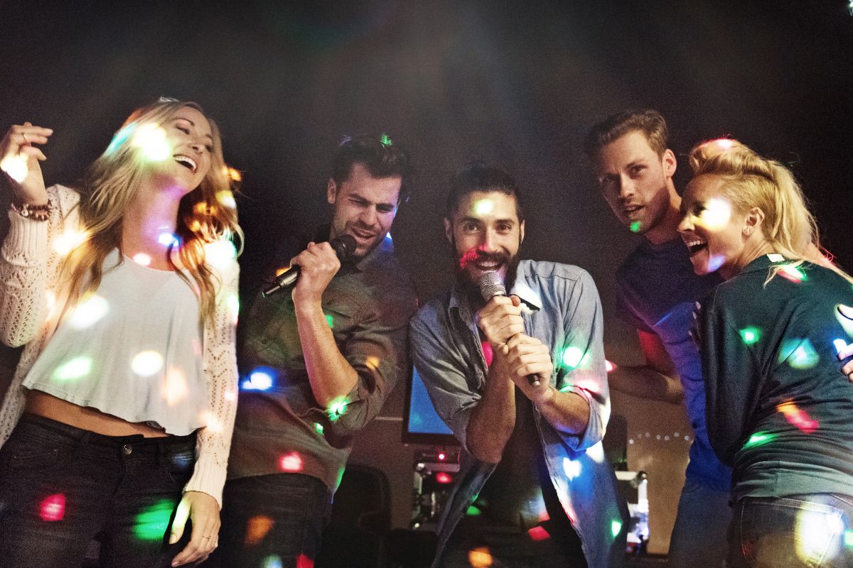 A picture of friends doing karaoke.