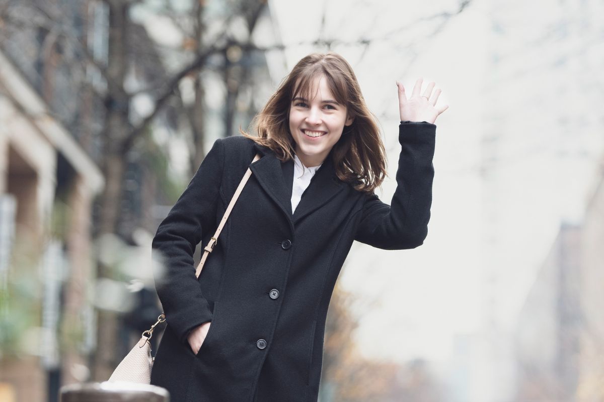 A picture of someone hailing a taxi.